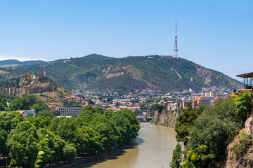Fototapeta na wymiar View across the River Mtkvari over the Old Town district towards the Tbilisi TV Tower on Mtatsminda mountain
