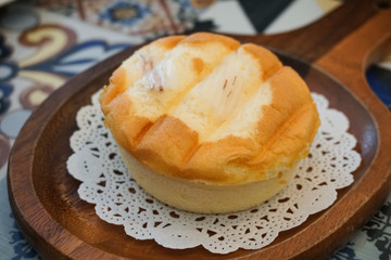 Obraz na płótnie Canvas Coconut Butter Cup Cake on Wood Dish