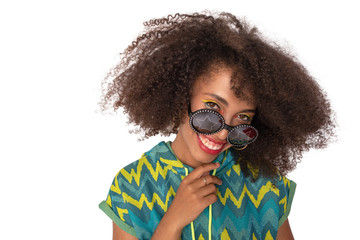 curly girl posing in the Studio on an isolated background. the girl is joking and fooling around. the girl looks charmingly and smiles