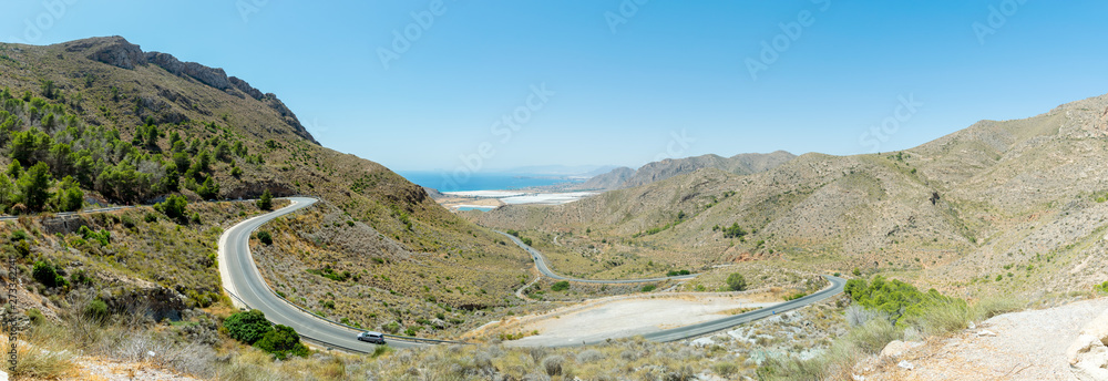 Wall mural A panoramic view form Mirador Cuestas del Cedacero overlooking a winding road in Cartagena, Spain