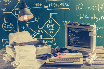 Programming work in computer lab on green blackboard background