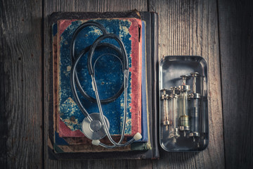 Top view of stethoscope and glass syringes as education concept