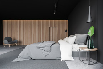 Side view of gray bedroom with armchair
