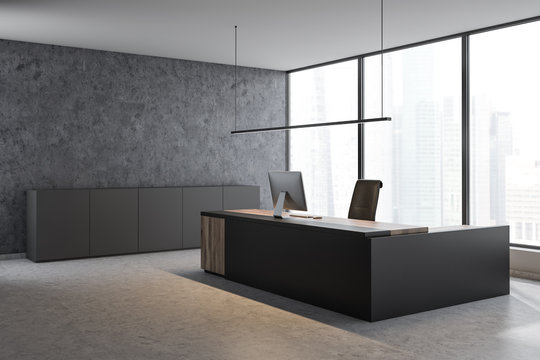Panoramic concrete CEO office with gray cabinets