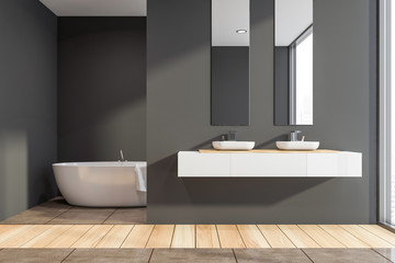 Fototapeta na wymiar Dark gray bathroom with double sink and tub