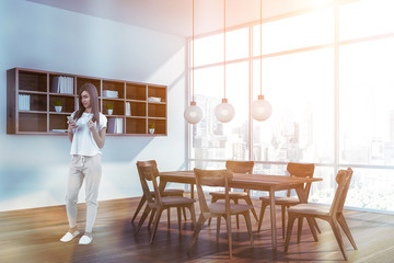 Woman in dining room with shelves