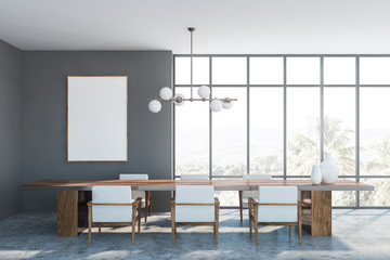 Gray dining room interior, armchairs and poster