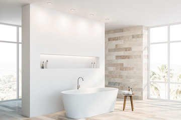 White and stone bathroom corner with tub