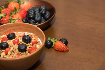 Fresh cereal and milk with strawberry and blueberry in bowl
