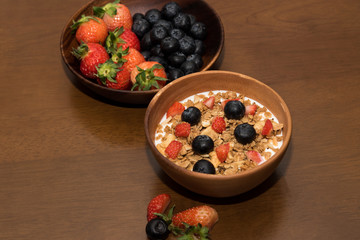 Fresh cereal and milk with strawberry and blueberry in bowl