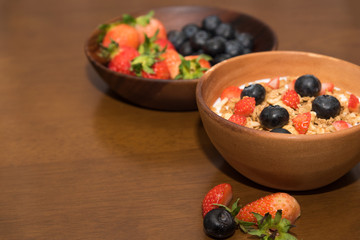 Fresh cereal and milk with strawberry and blueberry in bowl