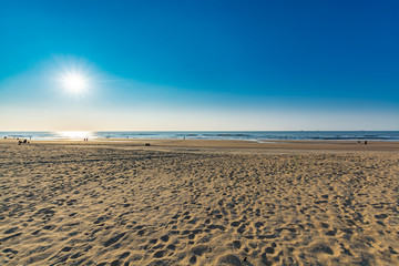 Fototapeta na wymiar Sunny day on North sea beach in Netherlands in Schegeningen, tourist and vacation destination in Europe