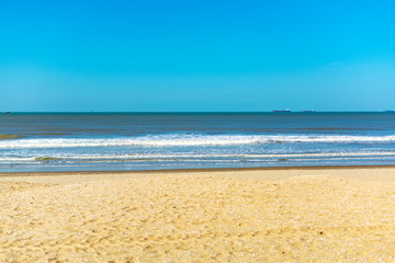 Fototapeta na wymiar Sunny day on North sea beach in Netherlands near Schegeningen