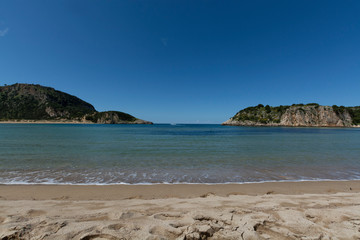 Voidokilia Beach, popular white sand and blue clear water beach in Messinia in Mediterranean area in shape of Greek letter omega, Peloponnese, Greece.