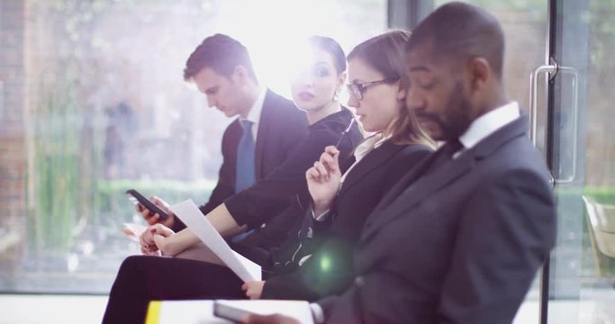 4K Bored businesswoman waiting in line for job interview gets fed up & leaves. Slow motion.