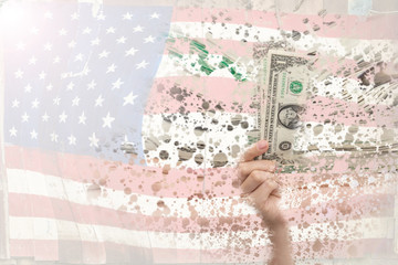 Hands showing banknotes on America flag background, The concept of a falling currency