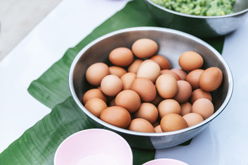 Boiled eggs in stainless bowl on banana leaves on the table in the Akha village of Maejantai on the hill in Chiang Mai, Thailand.