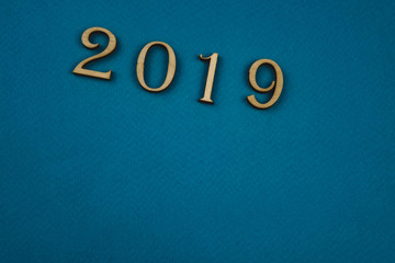 2019 number of wooden numbers on blue background