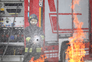firefighter with helmet and uniform in action