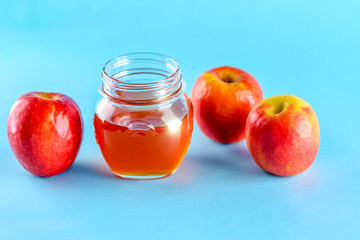 Rosh hashanah jewish holiday concept. Honey and apple over blue background. Healthy food.