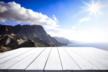 Desk of free space and aerial view of sea and mountains 