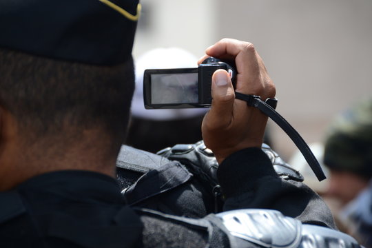A gendarme films the demonstrators during a demonstration