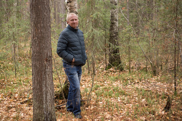 elderly man walking in the autumn forest