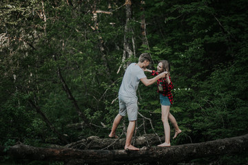 Naklejka na ściany i meble Beautiful couple walks in the woods