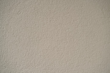 The texture of the wall with plaster with a rough surface is gray.