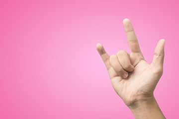 I Love You hand sign on paster pink background.