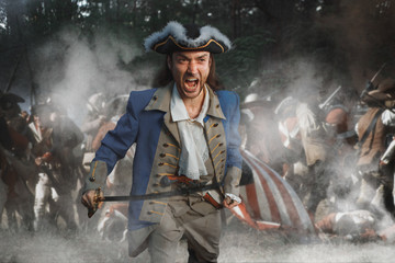 Man dressed as soldier of War of Independence USA attacks with saber in battle. 4 july independence...