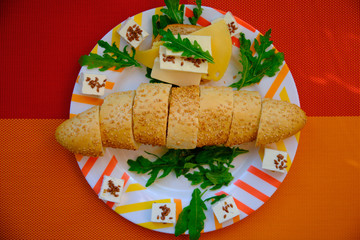 Fresh bread with cheese and basil for breakfast in a trip