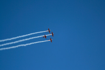 Four planes in the blue sky at the air show