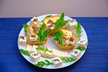 Fresh bread with cheese and basil for breakfast in a trip