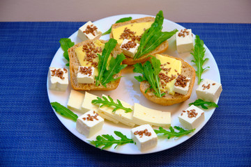 Fresh bread with cheese and basil for breakfast in a trip