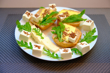 Fresh bread with cheese and basil for breakfast in a trip