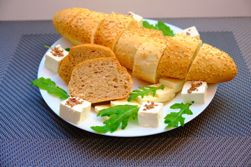 Fresh bread with cheese and basil for breakfast in a trip