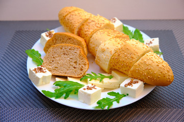 Fresh bread with cheese and basil for breakfast in a trip
