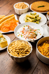 Group of Gujarati snacks like jalebi-fafda, thepla, khaman dhokla, aloo bhujiya, khandvi,khakra, dahi vada, gathiya with hot tea