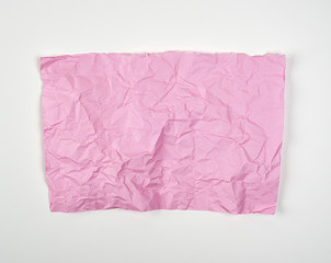 crumpled pink rectangular sheet of paper on a white background