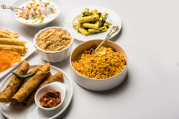 Group of Gujarati snacks like jalebi-fafda, thepla, khaman dhokla, aloo bhujiya, khandvi,khakra, dahi vada, gathiya with hot tea