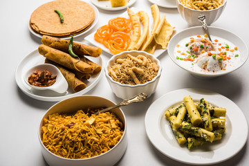 Group of Gujarati snacks like jalebi-fafda, thepla, khaman dhokla, aloo bhujiya, khandvi,khakra, dahi vada, gathiya with hot tea