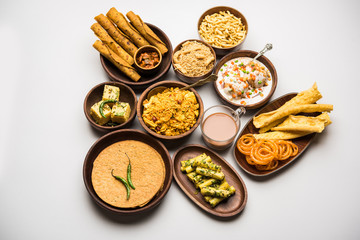 Group of Gujarati snacks like jalebi-fafda, thepla, khaman dhokla, aloo bhujiya, khandvi,khakra, dahi vada, gathiya with hot tea
