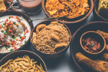 Group of Gujarati snacks like jalebi-fafda, thepla, khaman dhokla, aloo bhujiya, khandvi,khakra, dahi vada, gathiya with hot tea