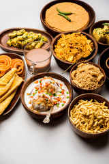 Group of Gujarati snacks like jalebi-fafda, thepla, khaman dhokla, aloo bhujiya, khandvi,khakra, dahi vada, gathiya with hot tea