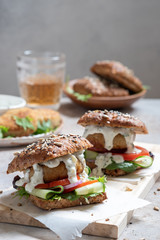Gourmet Fish seafood burger with mayo and fresh vegetables