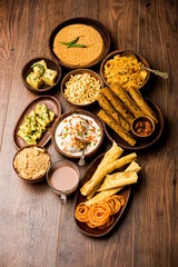 Group of Gujarati snacks like jalebi-fafda, thepla, khaman dhokla, aloo bhujiya, khandvi,khakra, dahi vada, gathiya with hot tea