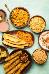 Group of Gujarati snacks like jalebi-fafda, thepla, khaman dhokla, aloo bhujiya, khandvi,khakra, dahi vada, gathiya with hot tea
