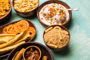 Group of Gujarati snacks like jalebi-fafda, thepla, khaman dhokla, aloo bhujiya, khandvi,khakra, dahi vada, gathiya with hot tea