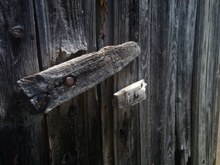 A close-up of a wooden latch of an old door.